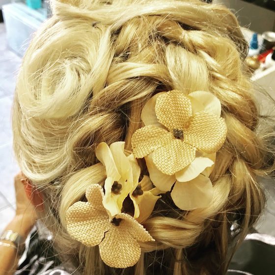 Blonde updo with cream fabric flowers